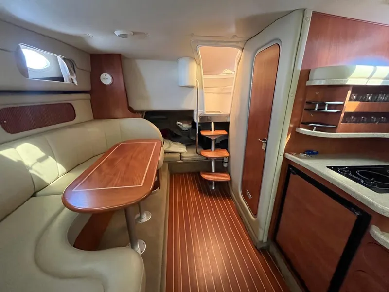 Slide: The Image of Interior of 2006 Rinker Fiesta Vee 342 yacht with wood accents and cozy seating. - 16