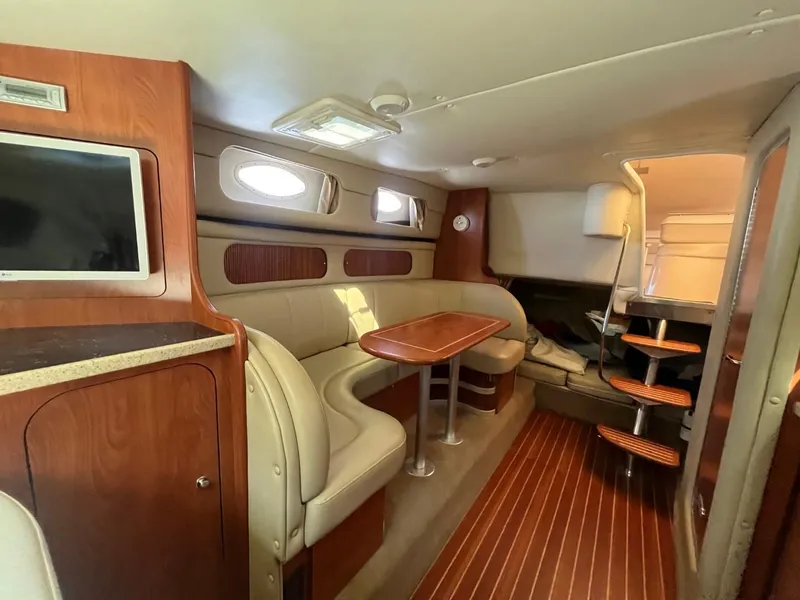 Slide: The Image of Interior of 2006 Rinker Fiesta Vee 342 yacht with wood accents and seating area. - 17