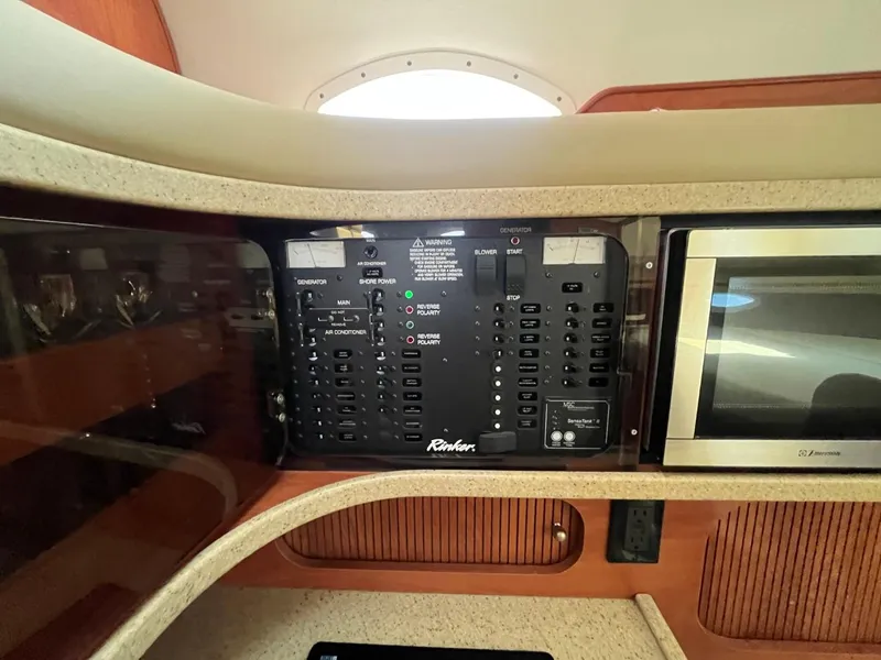 Slide: The Image of Control panel and microwave inside 2006 Rinker Fiesta Vee 342 boat cabin. - 19