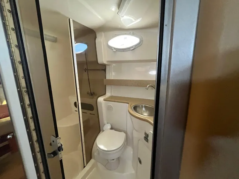 Slide: The Image of 2006 Rinker Fiesta Vee 342 boat bathroom with toilet, sink, and shower. - 22