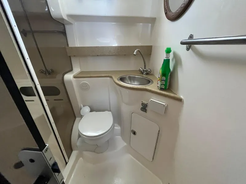 Slide: The Image of 2006 Rinker Fiesta Vee 342 bathroom with sink, toilet, and cleaning supplies. - 24