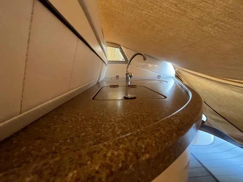 Slide: The Image of 2006 Rinker Fiesta Vee 342 boat interior with sleek kitchen countertop and sink. - 27