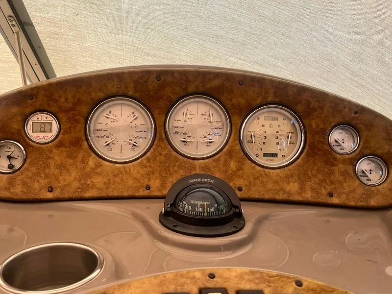 Slide: The Image of Dashboard of 2006 Rinker Fiesta Vee 342 boat with gauges and compass. - 7