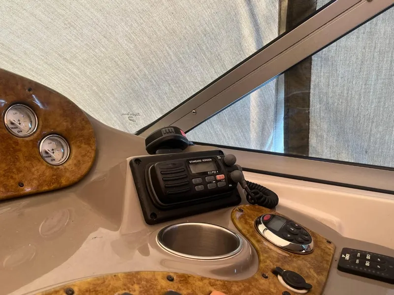 Slide: The Image of 2006 Rinker Fiesta Vee 342 dashboard with radio and gauges. - 8