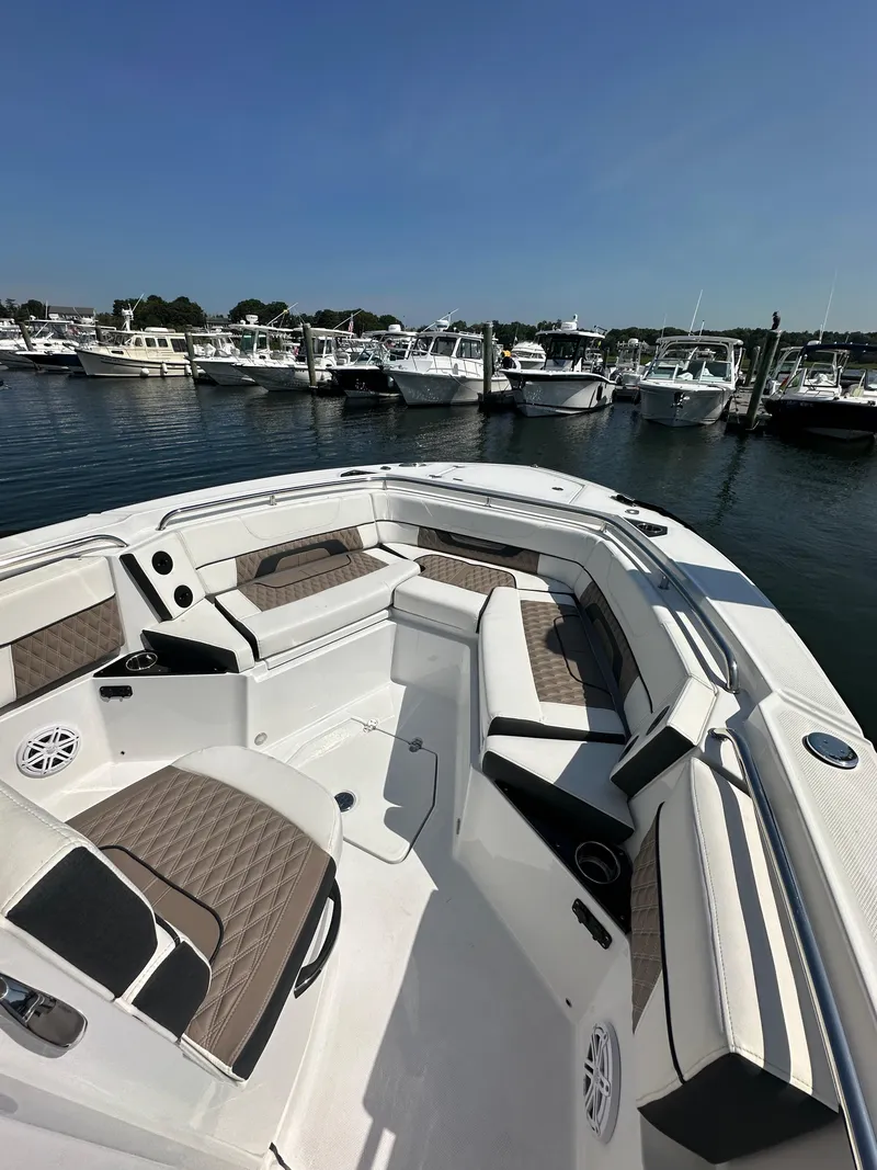Slide: The Image of 2023 Blackfin 252CC boat interior with seating, docked in marina. - 6