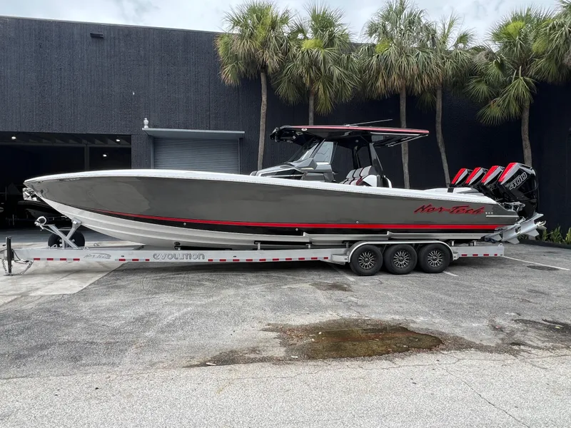 The Image of 2025 Nor-Tech 400 Supersport boat on trailer, parked outdoors near palm trees. - 1