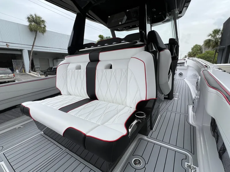Slide: The Image of 2025 Nor-Tech 400 Supersport boat interior with white and black seating, red accents. - 15