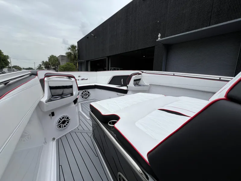 Slide: The Image of 2025 Nor-Tech 400 Supersport boat interior with sleek white and black seating. - 23