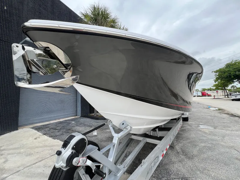 Slide: The Image of 2025 Nor-Tech 400 Supersport boat on trailer, sleek black and white design. - 4