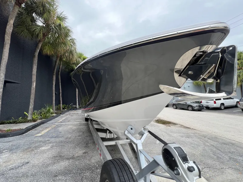 Slide: The Image of 2025 Nor-Tech 400 Supersport boat on trailer, parked near palm trees. - 5