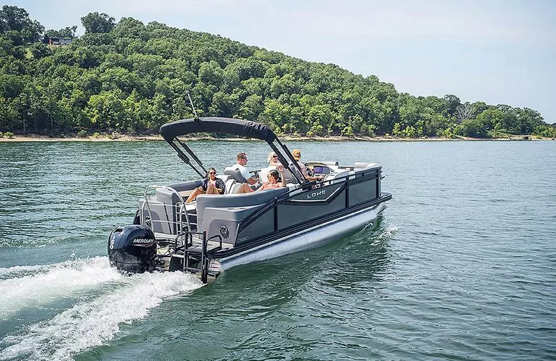 Slide: The Image of 2025 Lowe RS 250 WT pontoon boat cruising on a scenic lake. - 1