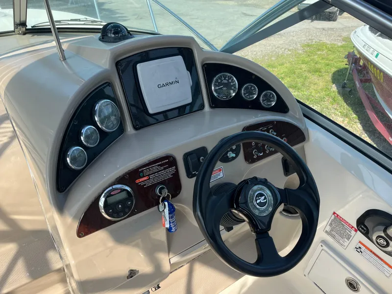 Slide: The Image of 2007 Sea Ray 270 Amberjack dashboard with Garmin navigation and steering wheel. - 12
