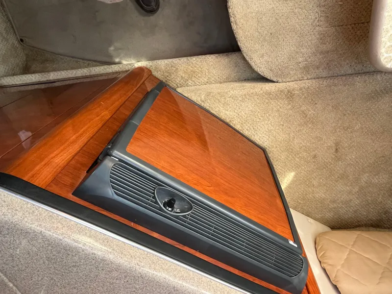 Slide: The Image of 2007 Sea Ray 270 Amberjack cabin interior with wood paneling and carpeted flooring. - 21