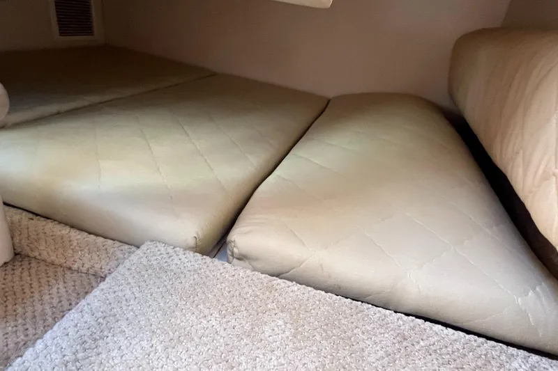 Slide: The Image of Interior cabin of 2007 Sea Ray 270 Amberjack with beige cushions and carpeted flooring. - 22