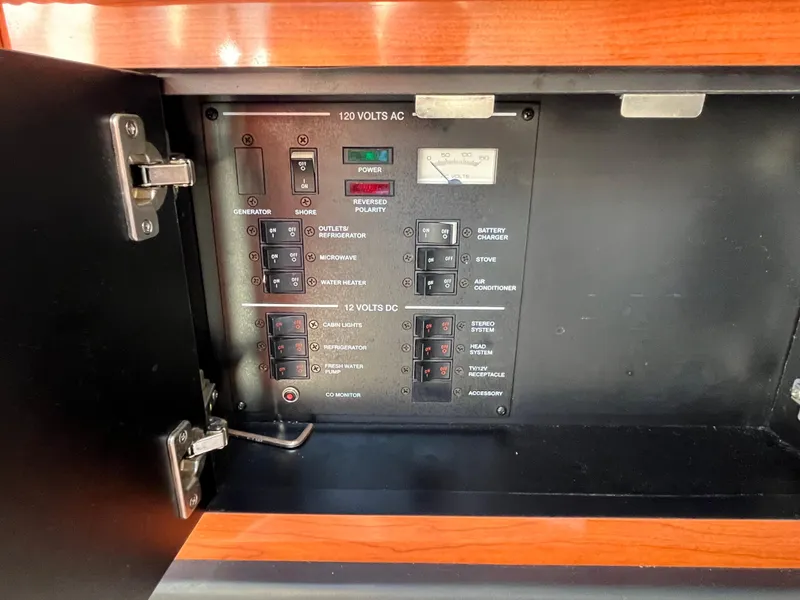 Slide: The Image of Electrical panel inside 2007 Sea Ray 270 Amberjack boat, featuring AC and DC switches. - 24