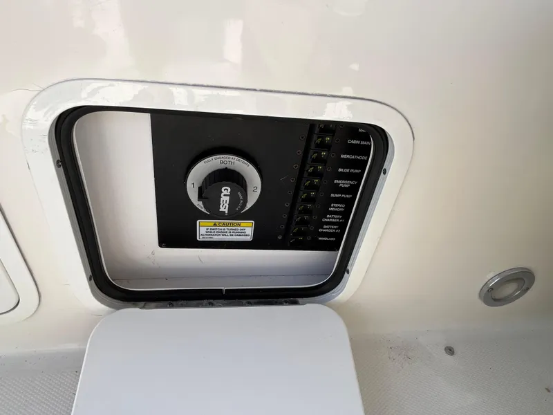 Slide: The Image of 2007 Sea Ray 270 Amberjack control panel with switches and dial. - 26