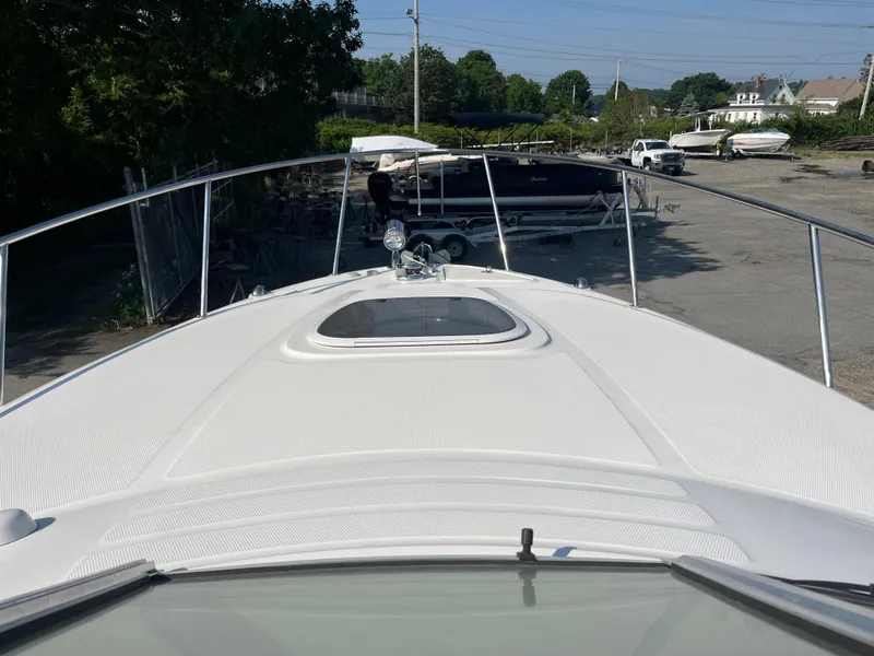 Slide: The Image of 2007 Sea Ray 270 Amberjack boat deck view in a marina setting. - 32