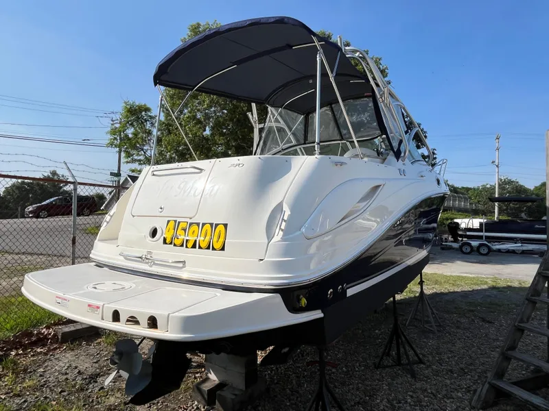 Slide: The Image of 2007 Sea Ray 270 Amberjack boat on stands, price displayed, sunny day. - 4
