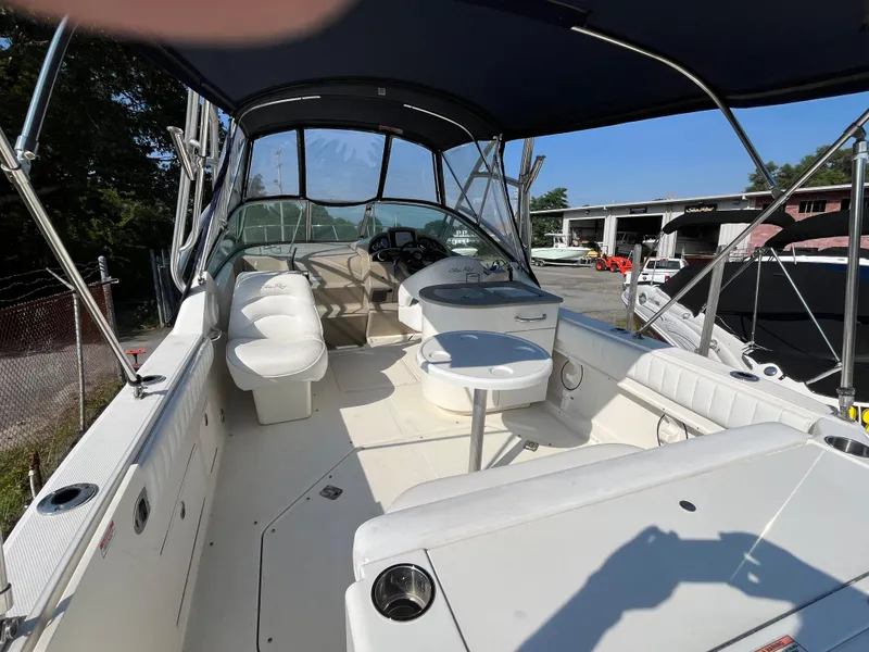Slide: The Image of 2007 Sea Ray 270 Amberjack boat interior with seating and table under canopy. - 5
