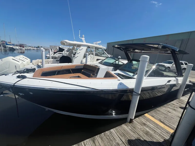 The Image of 2024 Cobalt R33 boat docked at marina, featuring sleek design and spacious seating. - 0