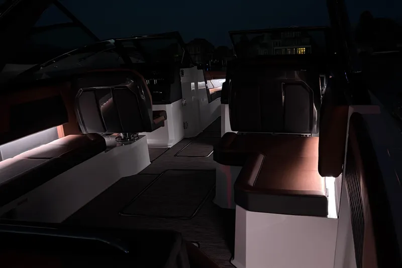 Slide: The Image of 2024 Cobalt R33 boat interior with ambient lighting and luxurious seating. - 18
