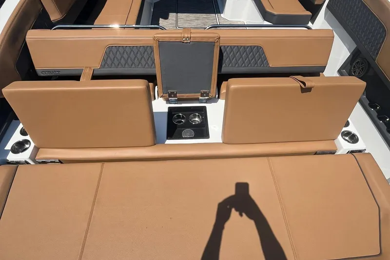 Slide: The Image of 2024 Cobalt R33 boat interior with tan leather seats and cup holders. - 4