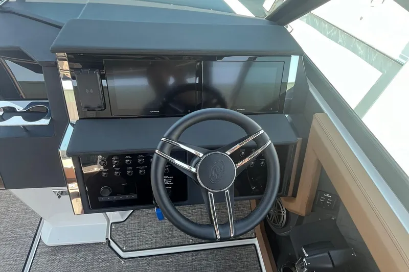 Slide: The Image of 2024 Cobalt R33 boat dashboard with steering wheel and dual display screens. - 7