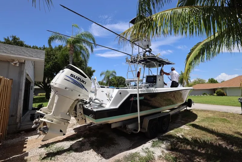 Slide: The Image of 2001 Contender 27 Open boat with Suzuki outboard motor on trailer. - 13