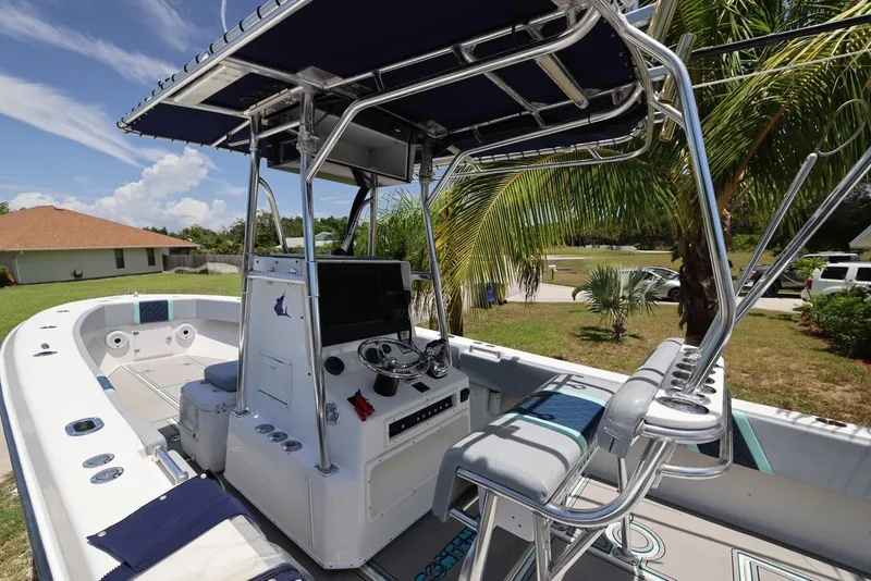 Slide: The Image of 2001 Contender 27 Open boat with T-top and dual helm seats. - 16