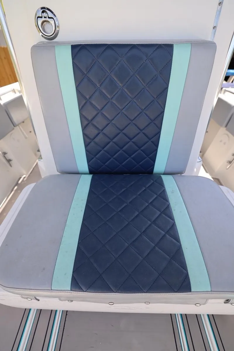 Slide: The Image of Contender 27 Open 2001 boat seat with blue and teal diamond-pattern upholstery. - 20