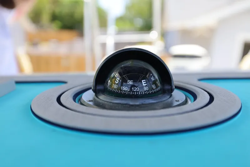 Slide: The Image of Close-up of a compass on a 2001 Contender 27 Open boat. - 21