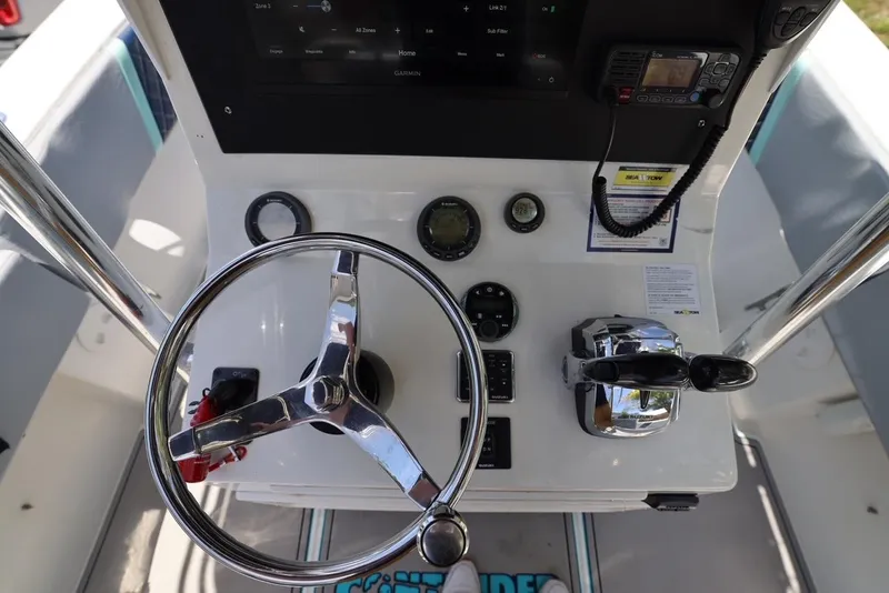 Slide: The Image of 2001 Contender 27 Open boat helm with steering wheel and controls - 25