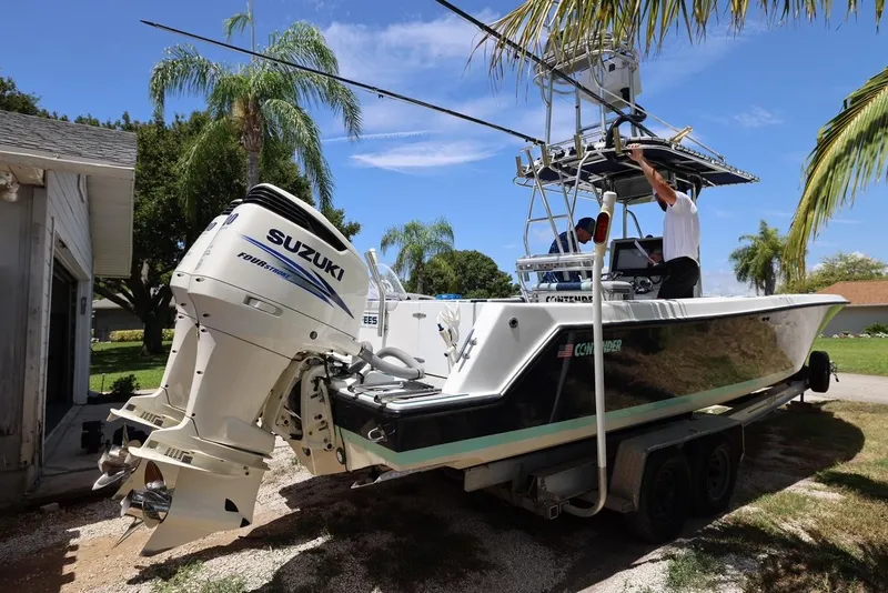 Slide: The Image of 2001 Contender 27 Open boat with Suzuki outboard engines on a trailer. - 3