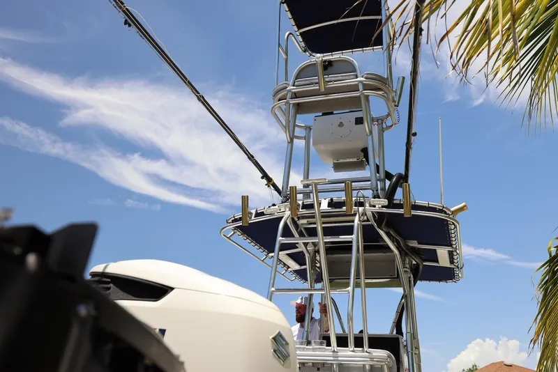 Slide: The Image of 2001 Contender 27 Open boat with tower and equipment against blue sky. - 33