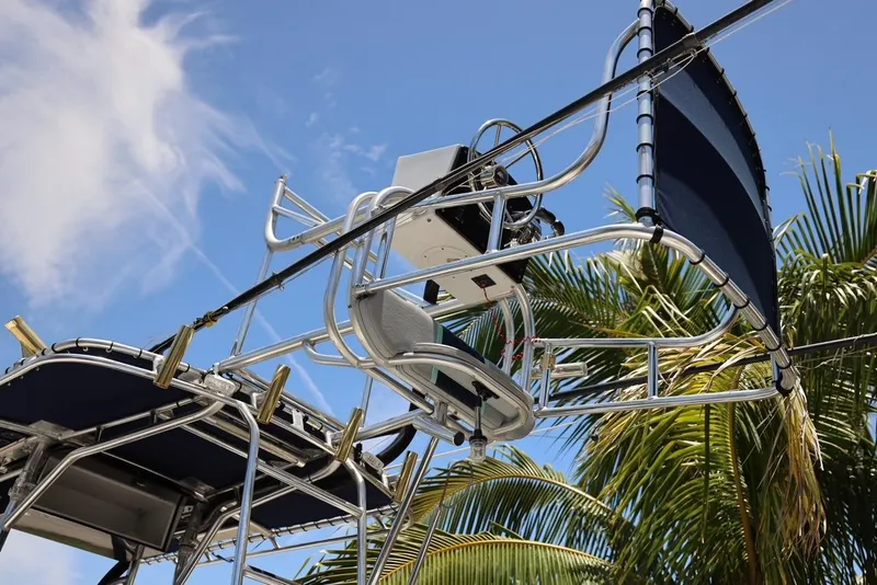 Slide: The Image of 2001 Contender 27 Open boat tower against a blue sky and palm trees. - 34