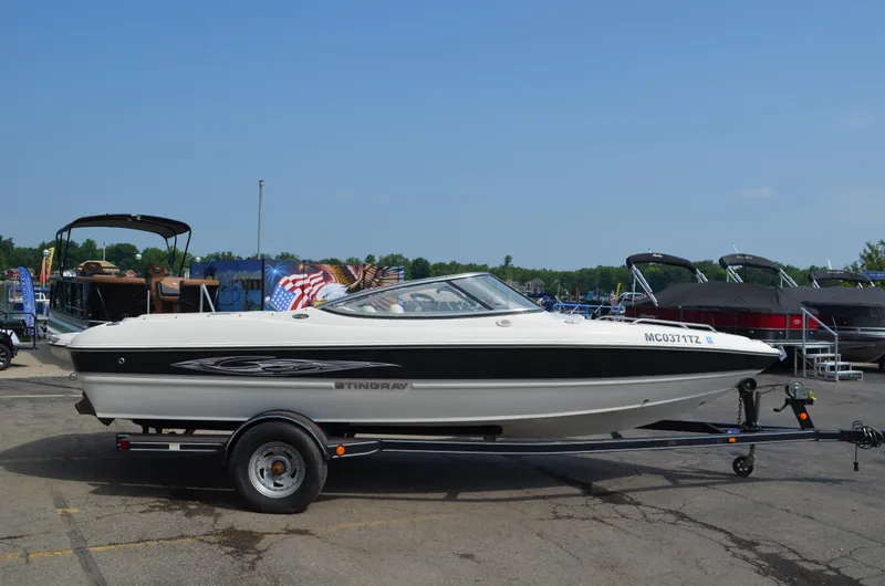 Slide: The Image of 2009 Stingray 205LX boat on trailer in parking lot. - 2