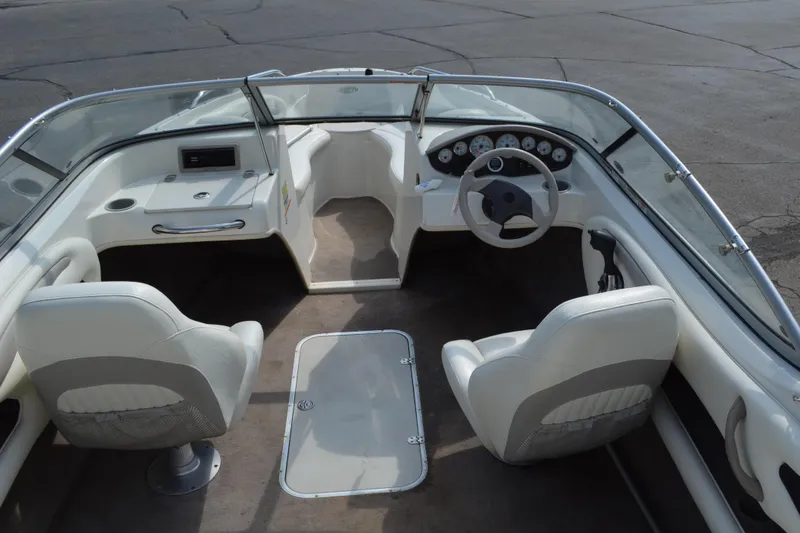 Slide: The Image of 2009 Stingray 205LX boat interior with white seating and dashboard. - 4