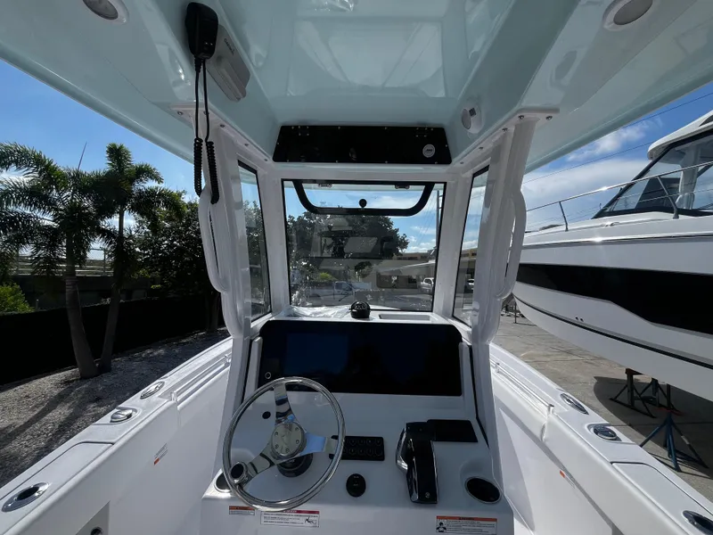 Slide: The Image of 2026 Sportsman Open 212 Center Console boat interior with steering wheel and controls. - 12