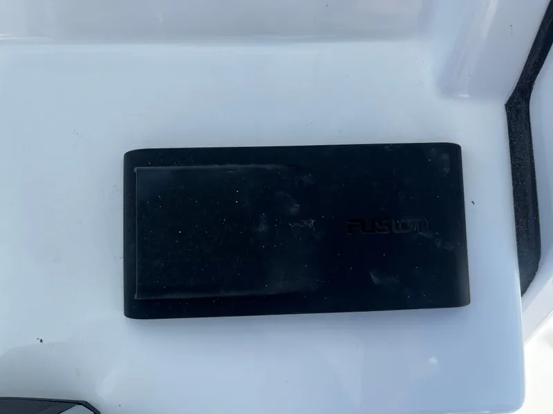 Slide: The Image of Black device on a white surface, possibly a component of a 2026 Sportsman Open 212 Center Console. - 14