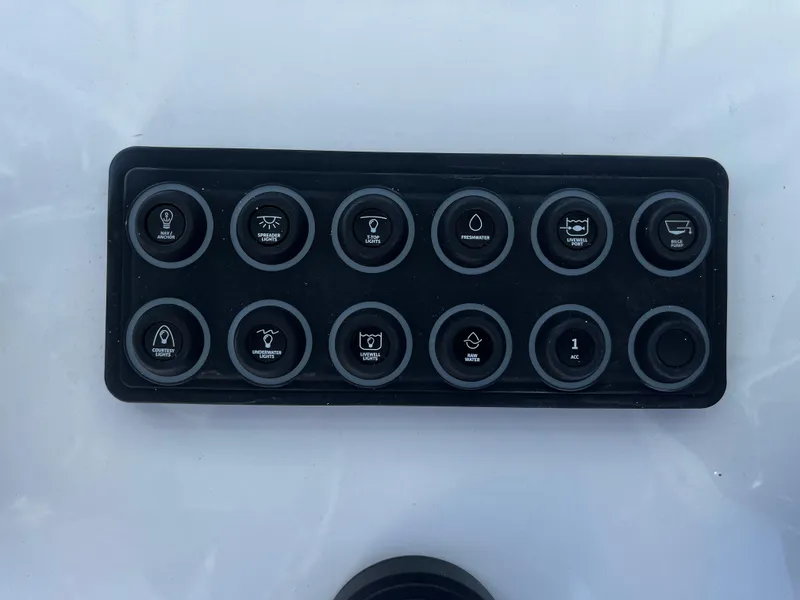 Slide: The Image of Control panel of 2026 Sportsman Open 212 Center Console boat with labeled buttons. - 15