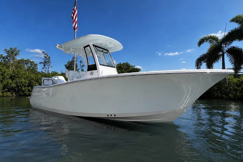 The Image of 2026 Sportsman Open 212 Center Console boat on calm water, with clear blue sky. - 0