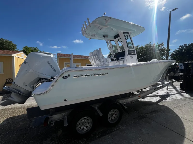 Slide: The Image of 2026 Sportsman Open 212 Center Console boat on trailer under clear blue sky. - 2