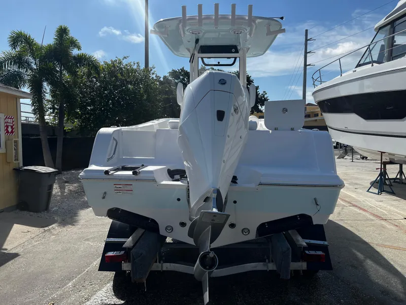Slide: The Image of 2026 Sportsman Open 212 Center Console boat on trailer, rear view, sunny day. - 3