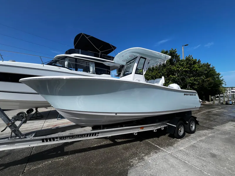 Slide: The Image of 2026 Sportsman Open 212 Center Console boat on trailer, parked outdoors. - 6