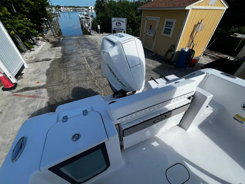 Slide: The Image of 2026 Sportsman Open 212 Center Console boat at dock with outboard motor. - 8