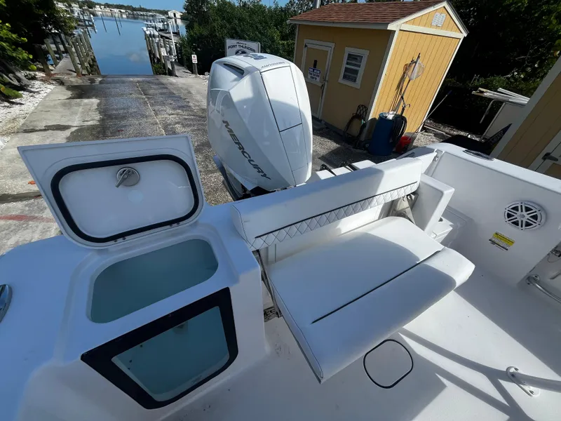 Slide: The Image of 2026 Sportsman Open 212 Center Console boat with Mercury outboard engine at dock. - 9