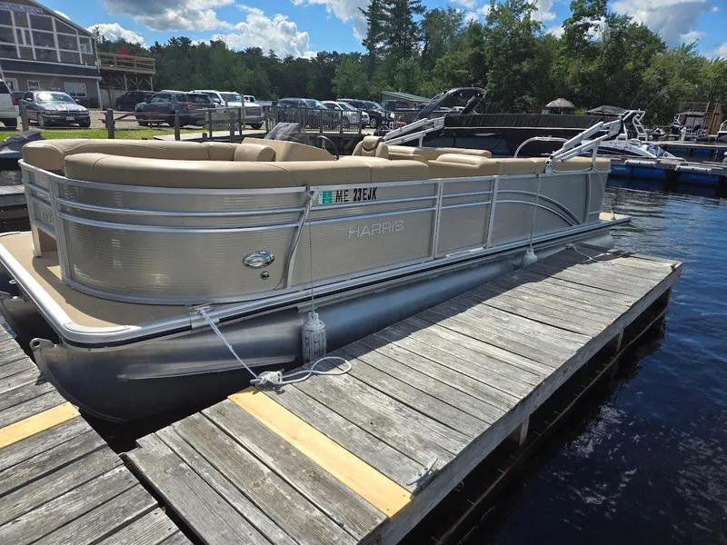 Slide: The Image of 2021 Harris Cruiser 230 pontoon boat docked on a sunny day. - 3