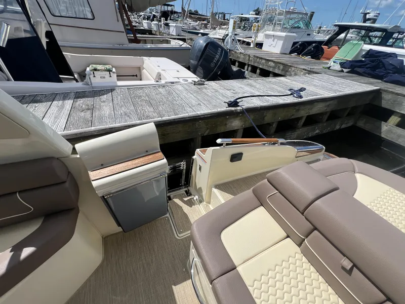 Slide: The Image of 2023 Chris-Craft Launch 28 GT at dock, showcasing luxurious seating and elegant design. - 14