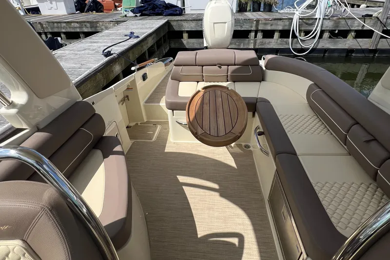 Slide: The Image of Luxurious interior of 2023 Chris-Craft Launch 28 GT boat with elegant seating and wooden accents. - 17