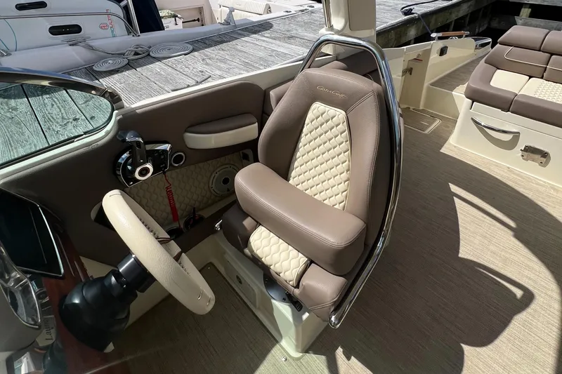 Slide: The Image of 2023 Chris-Craft Launch 28 GT interior with luxurious seating and steering wheel. - 25
